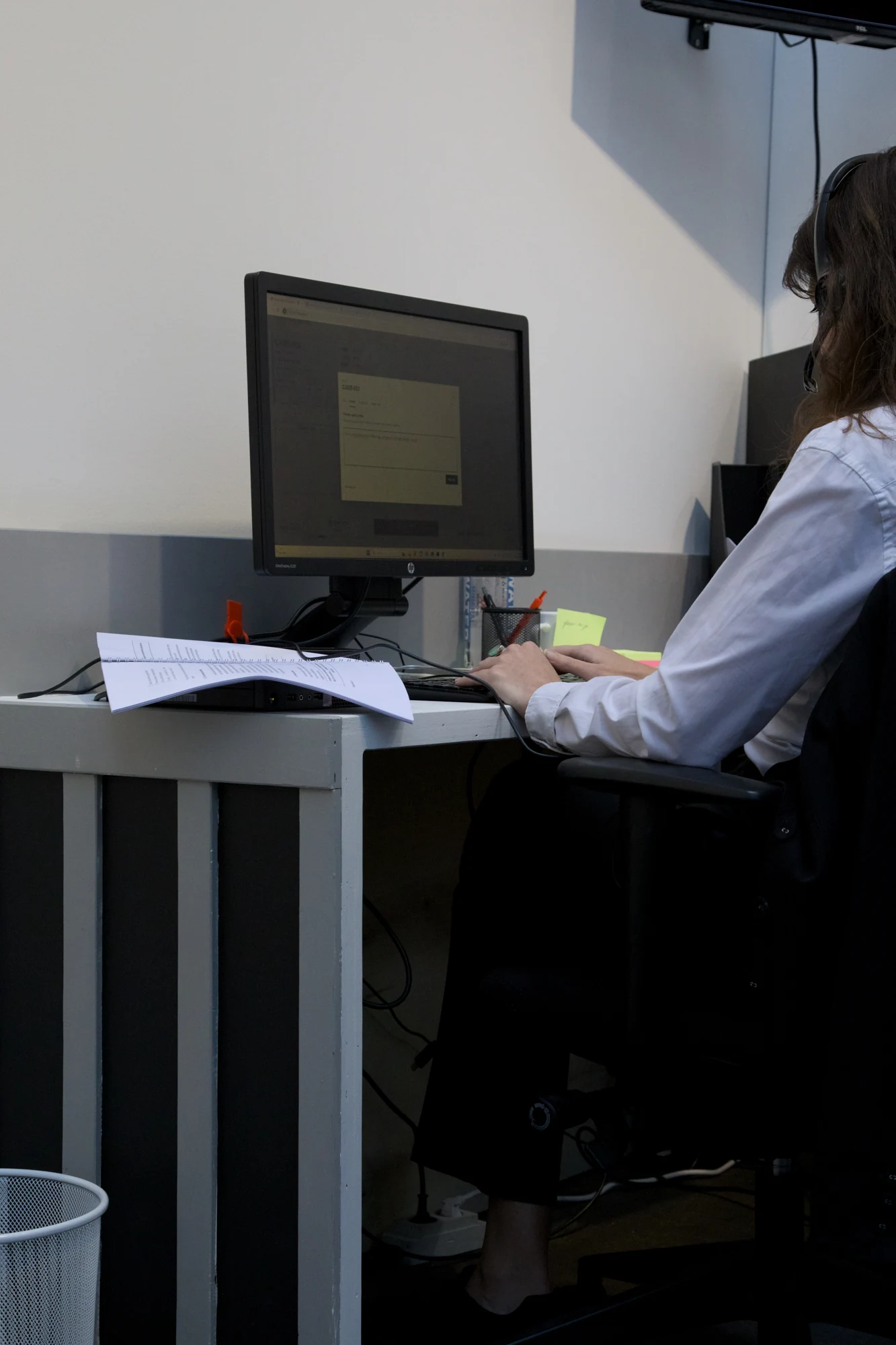 A seated agent taking a call at their desk.