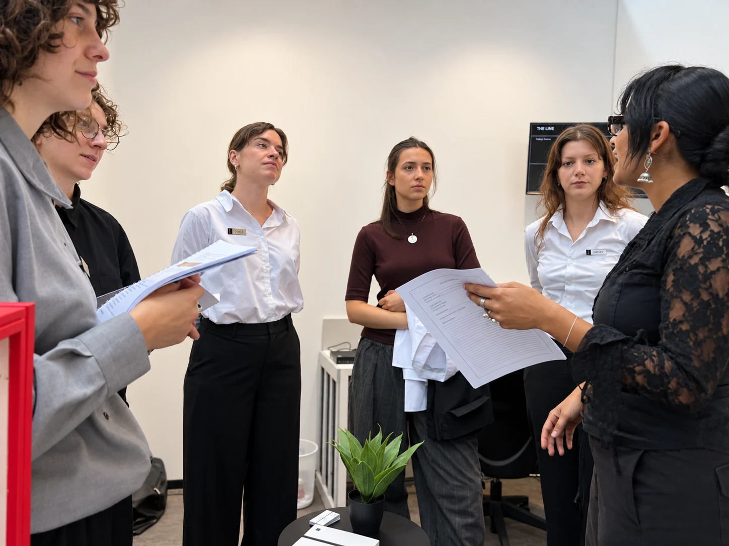 The team gathered for a briefing, holding printed copies of the agents’ manual.